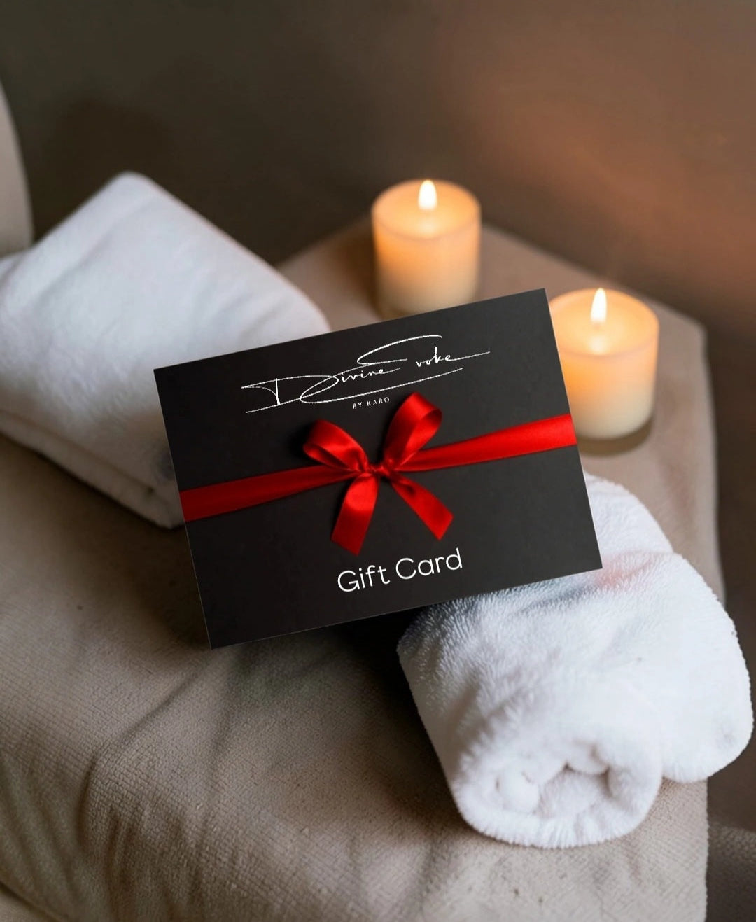 Divine Evoke by Kara Gift Card with red ribbon on a white towel
